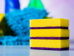 Adhesive systems for kitchen sponges